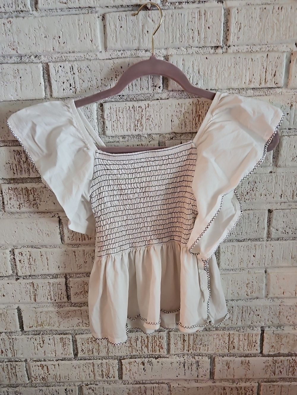 100 % Cotton. White Smocked Flutter Sleeve Top